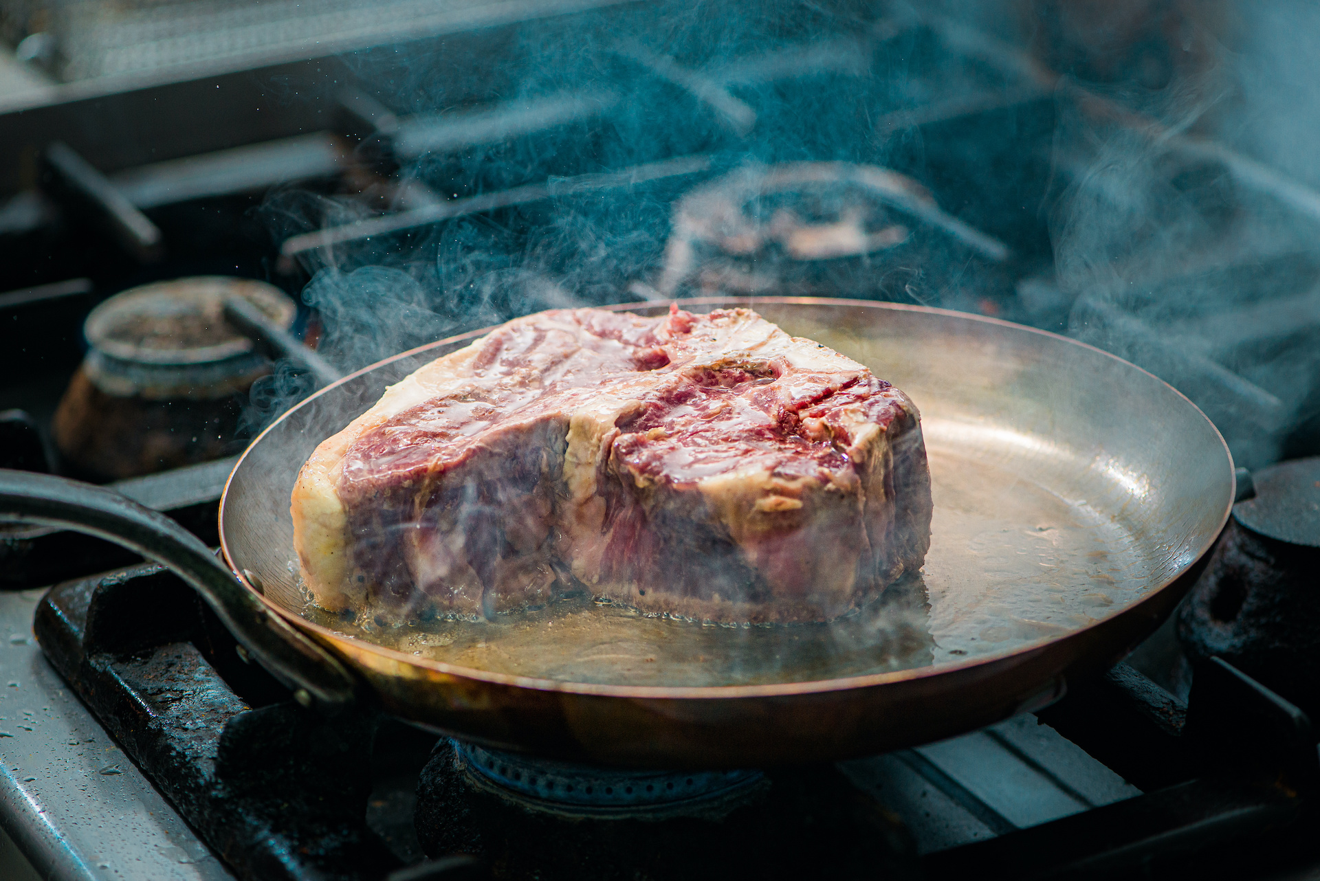 Steak frying in a pan