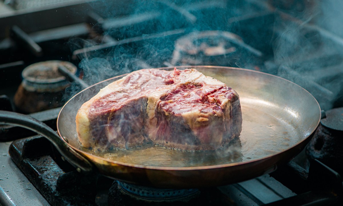 Steak frying in a pan
