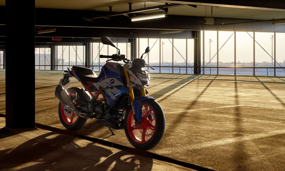 BMW G 310 R parked in an indoor garage with a view of water.