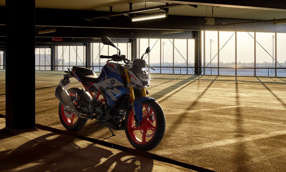 BMW G 310 R parked in an indoor garage with a view of water.