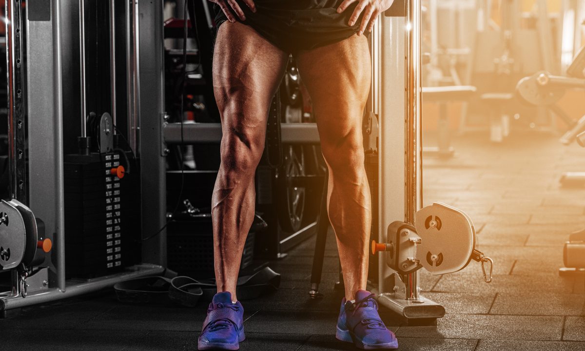Man with strong legs by cable machine