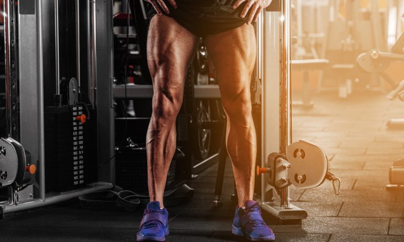 Man with strong legs by cable machine