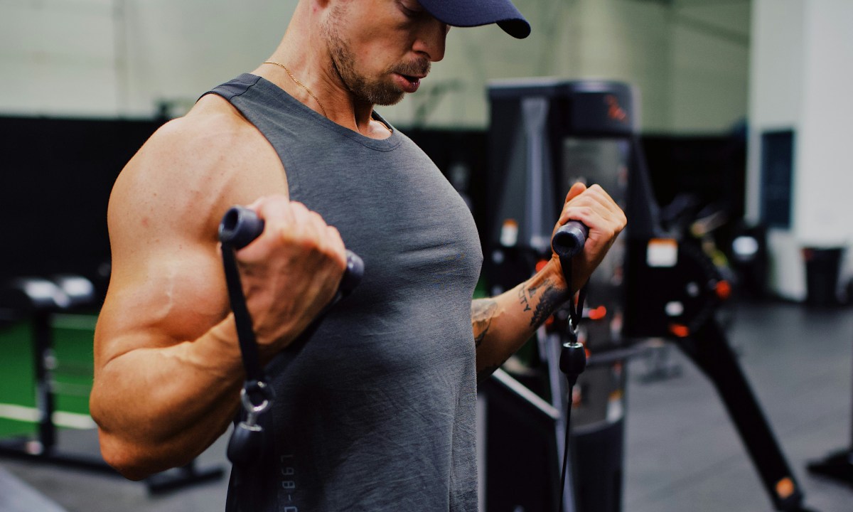 Man doing cable curls.