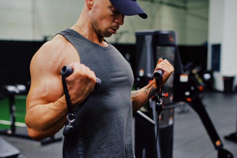 Man doing cable curls.