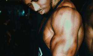 Man close-up flexing arm muscles triceps biceps