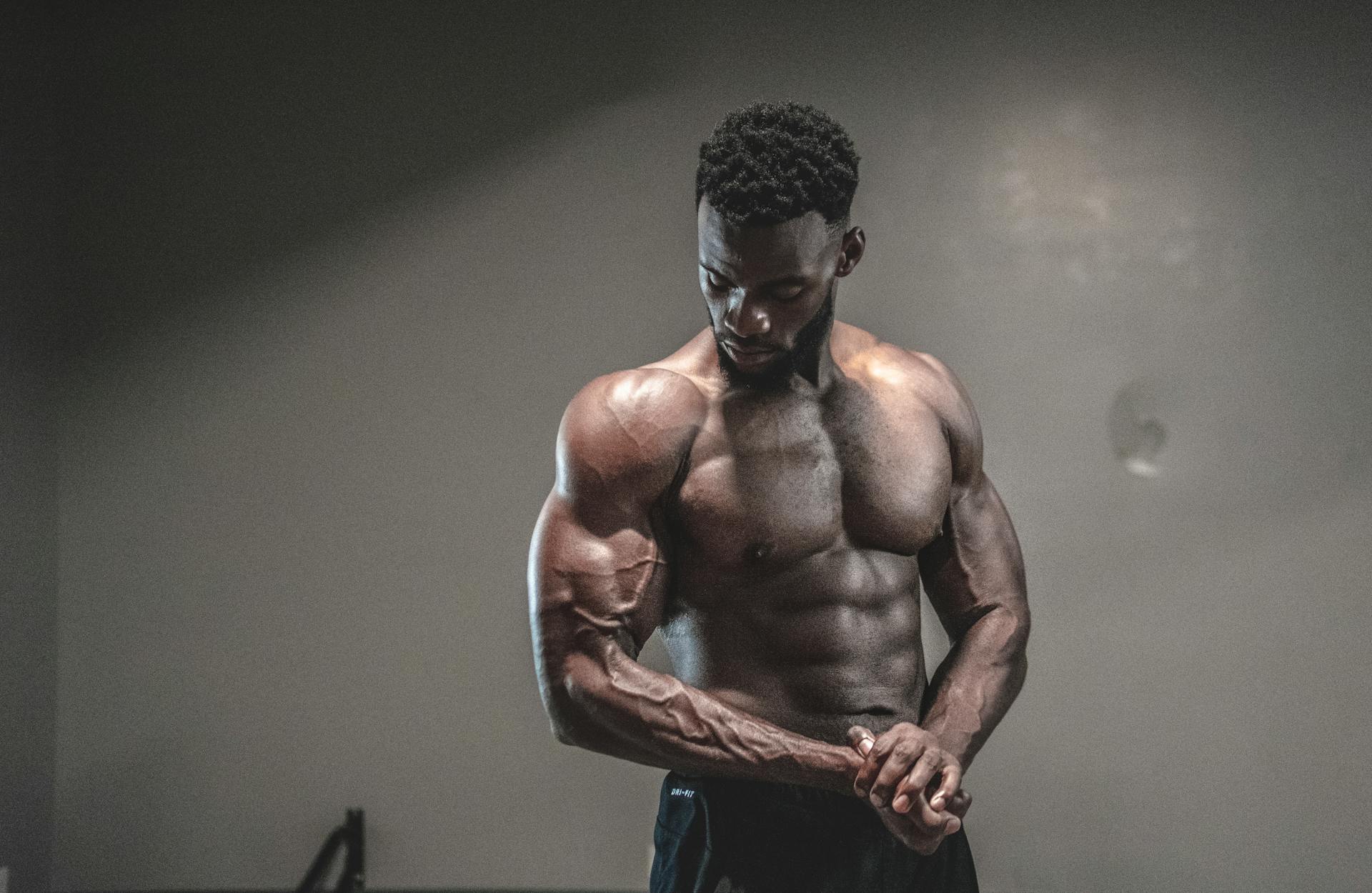 Muscular man with shirt off flexing muscles