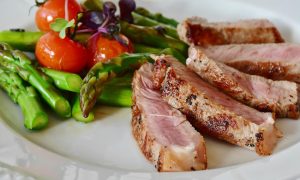 Dinner plate with cooked meat and vegetables
