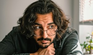 Man with long hair and glasses