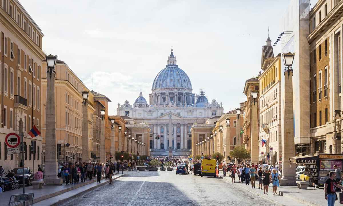 people walking beside white and brown dome building during daytime