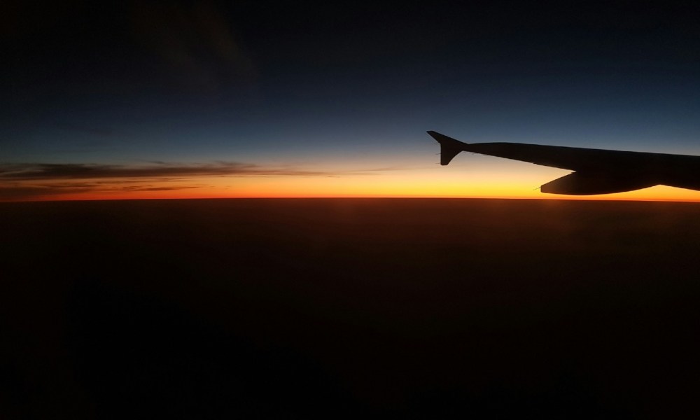 Sunset over airplane wing