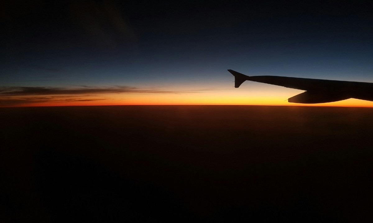 Sunset over airplane wing
