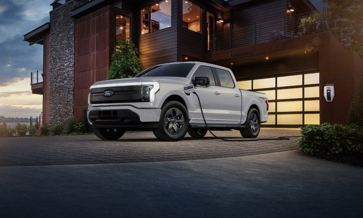 Ford Lightning F-150 plugged into a Level II DC Fast charger parked in a residential driveway