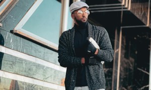 Man in cardigan and flat cap