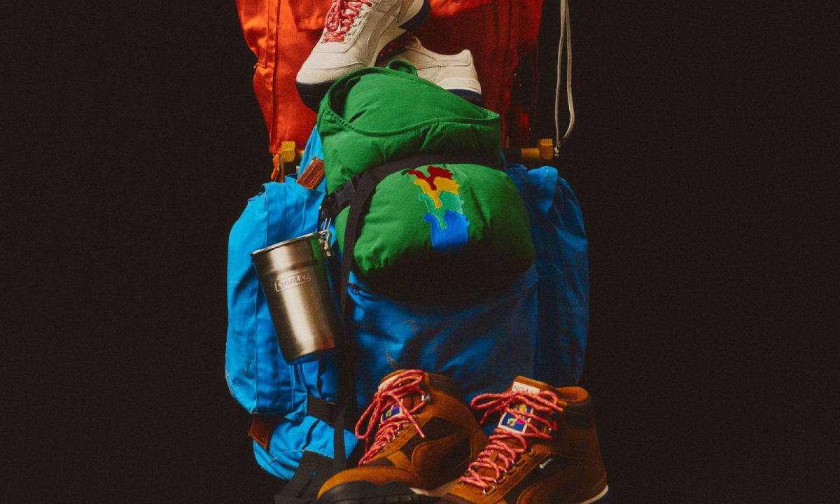 both hiking boots arranged around hiking gear