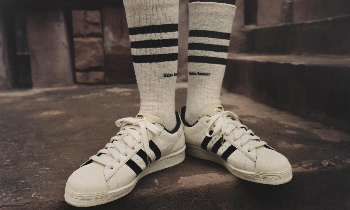Person wearing adidas Croc Superstar sneakers