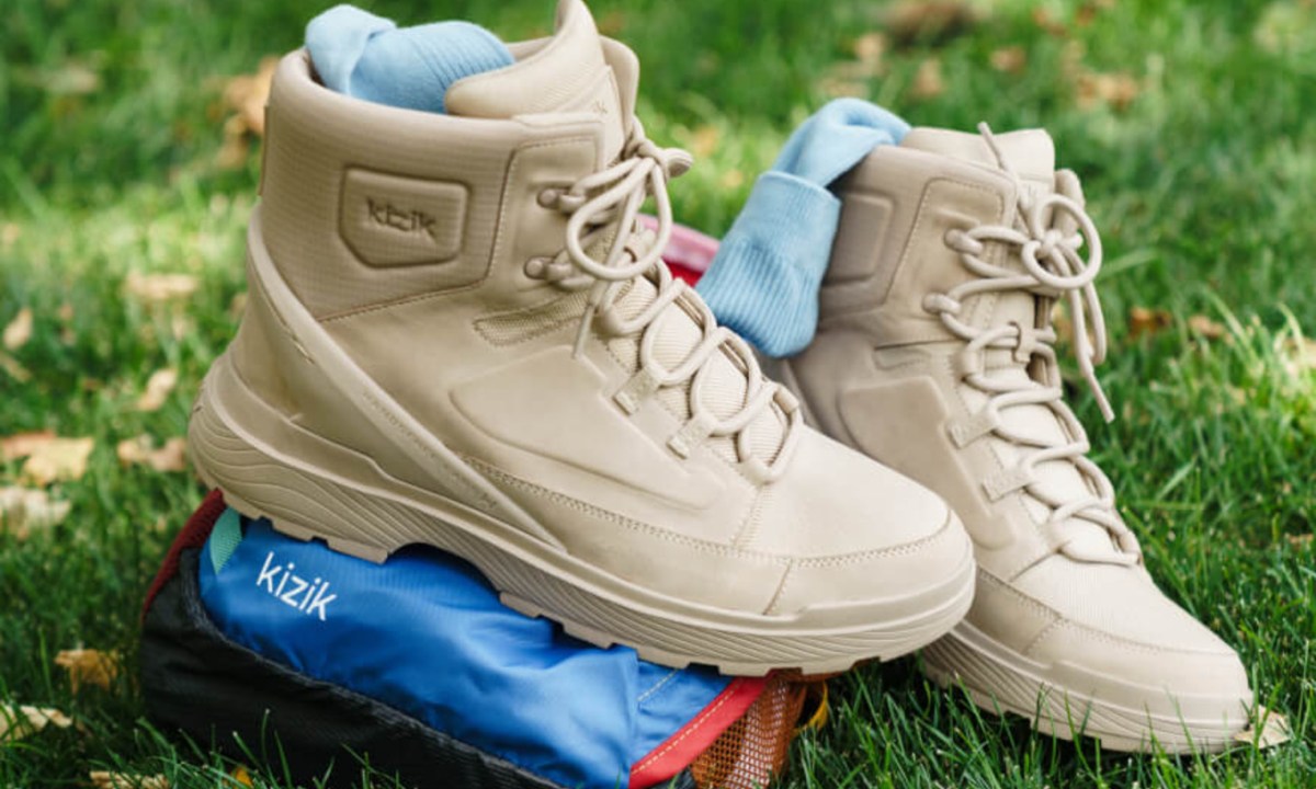 two hiking boots on the grass