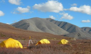 least visited national parks three bright yellow tents on red autumn tundra with mountains blue sky  amp survey equipment