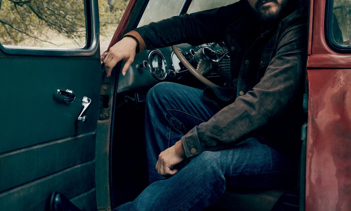 Cole Hauser sitting in red truck