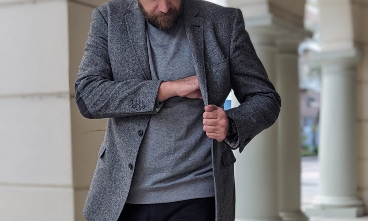 Man in gray tweed and jeans