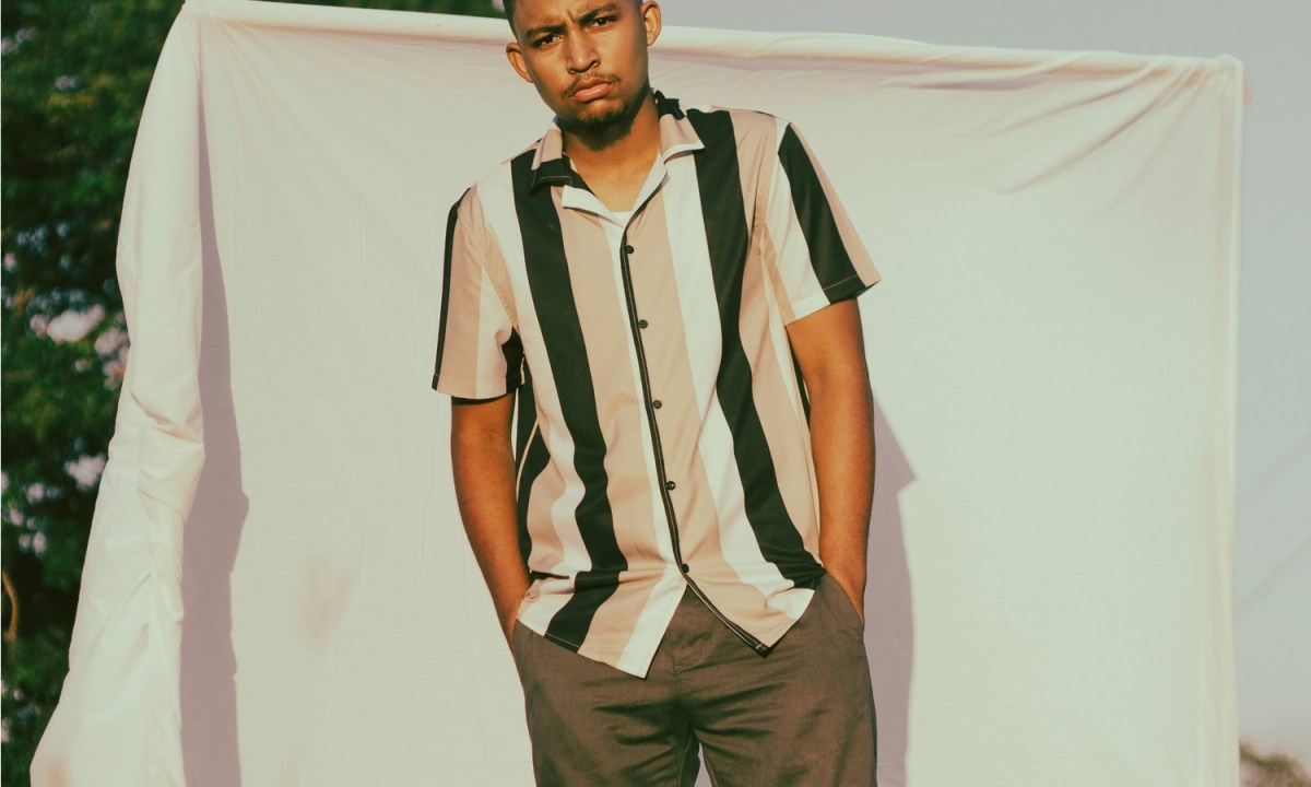 Man in striped polo and brown pants
