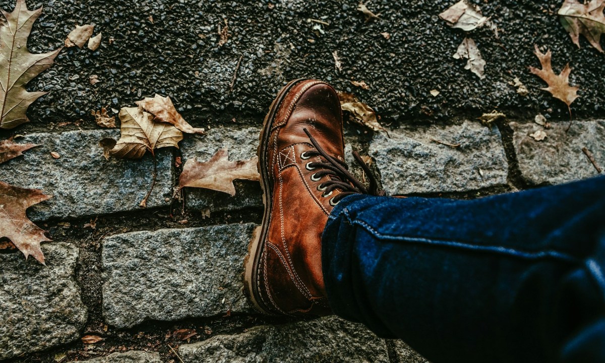 man wearing boots on street