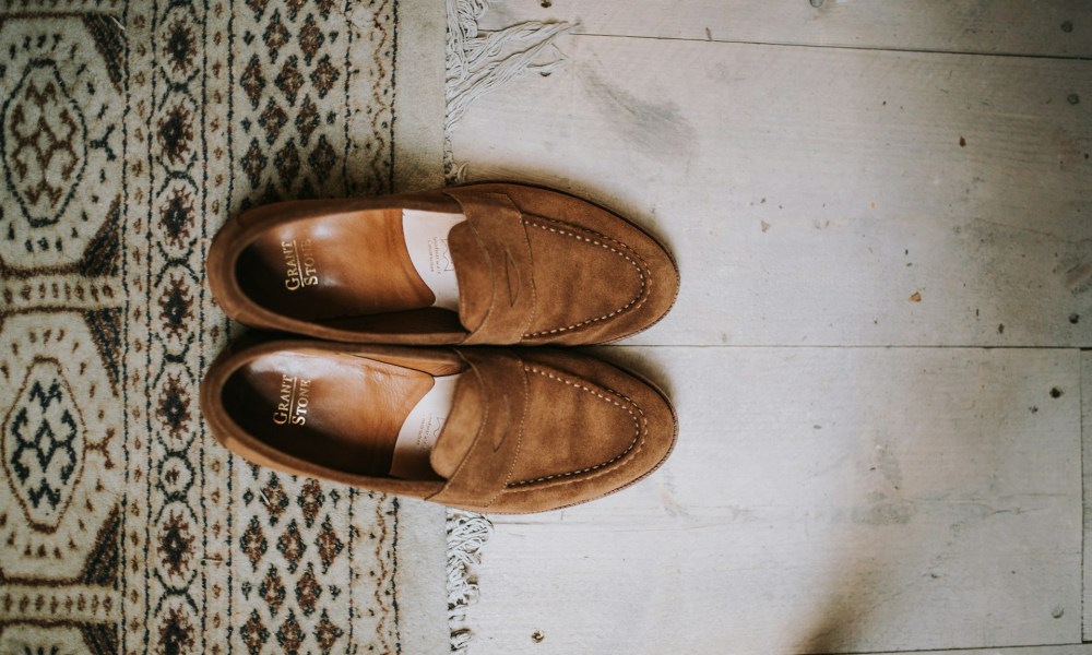 Overhead image of suede shoes on floor