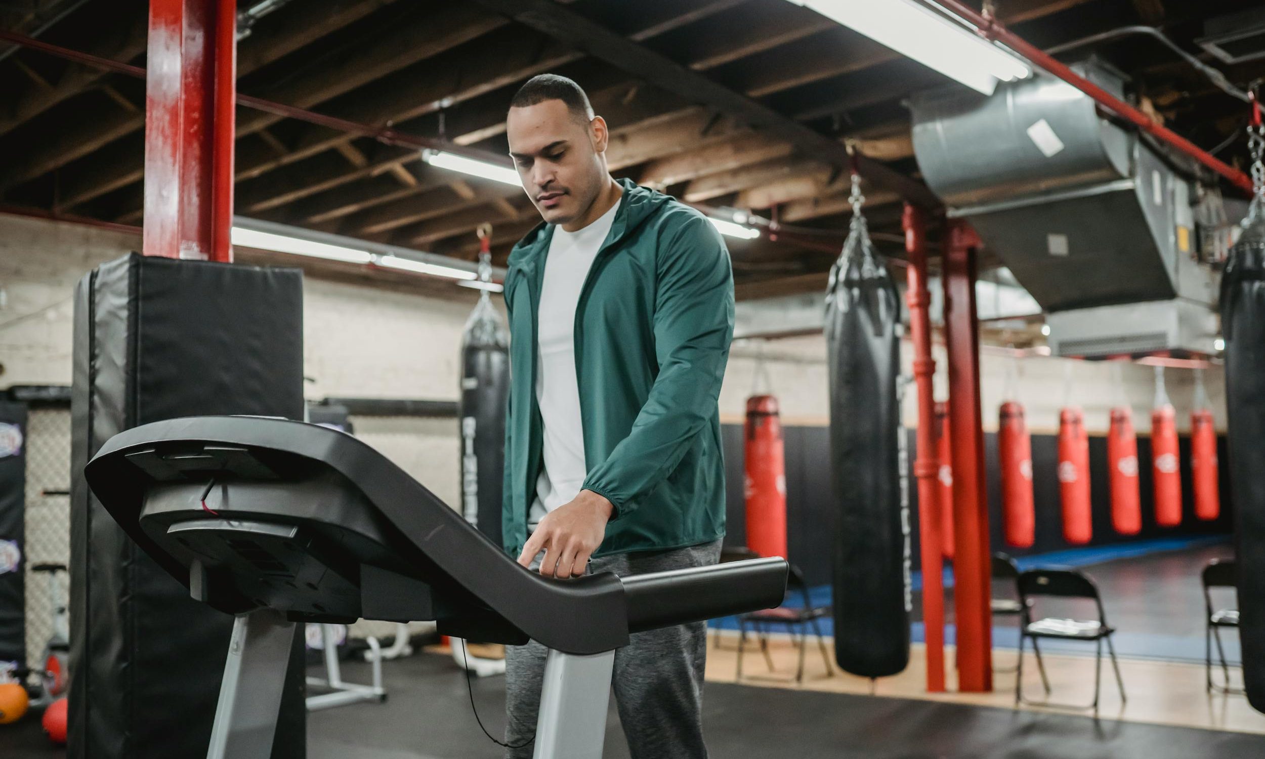 Man on treadmill walking using machine in gym