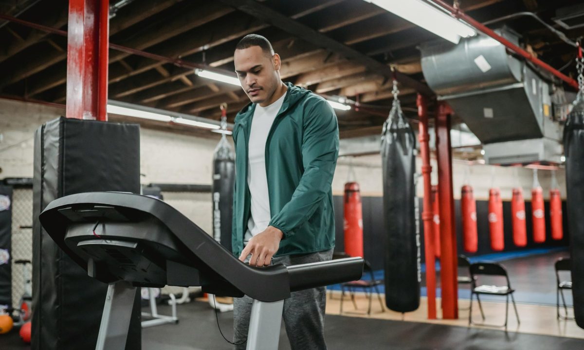Man on treadmill walking using machine in gym