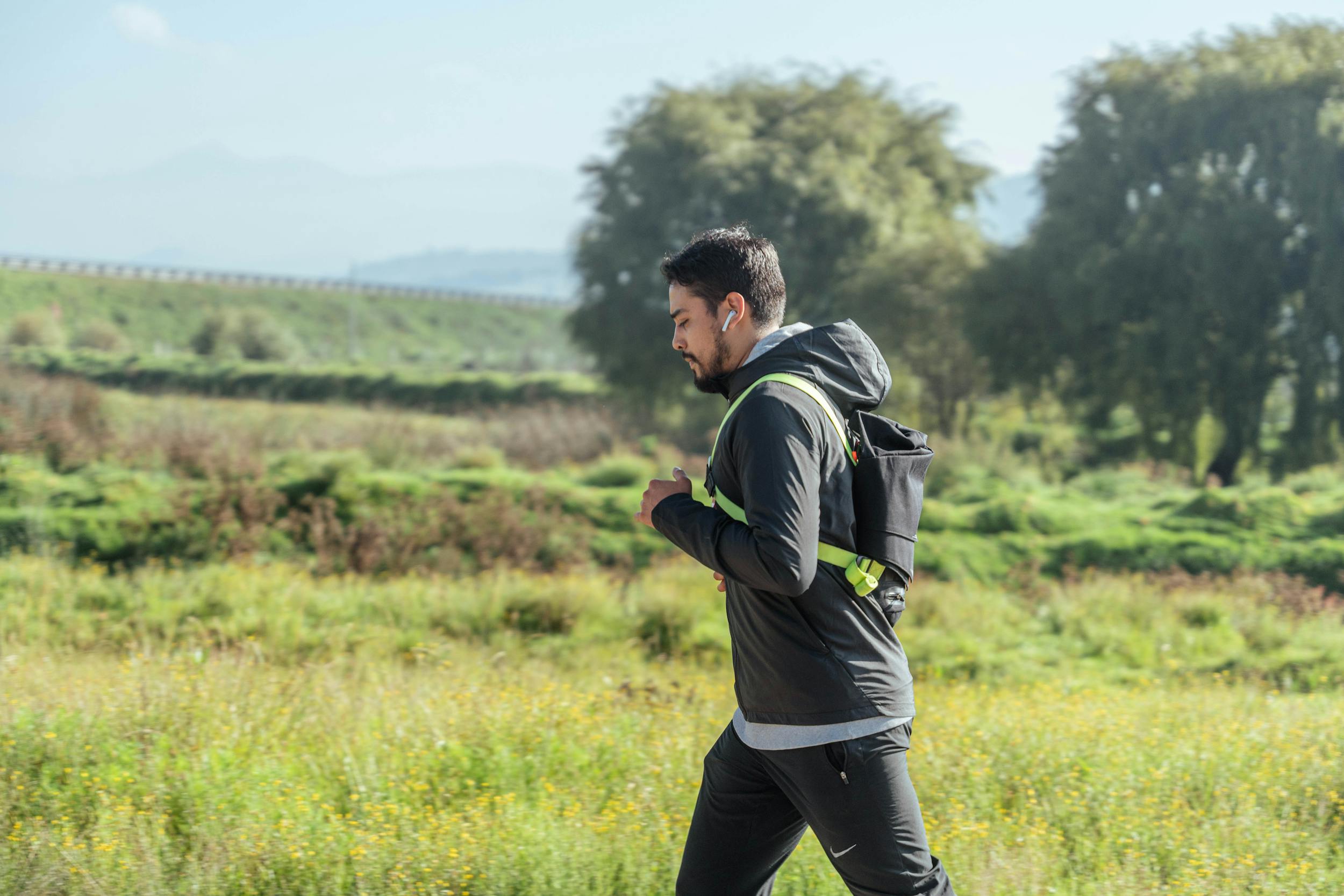 Man jogging brisk walking outdoors in nature