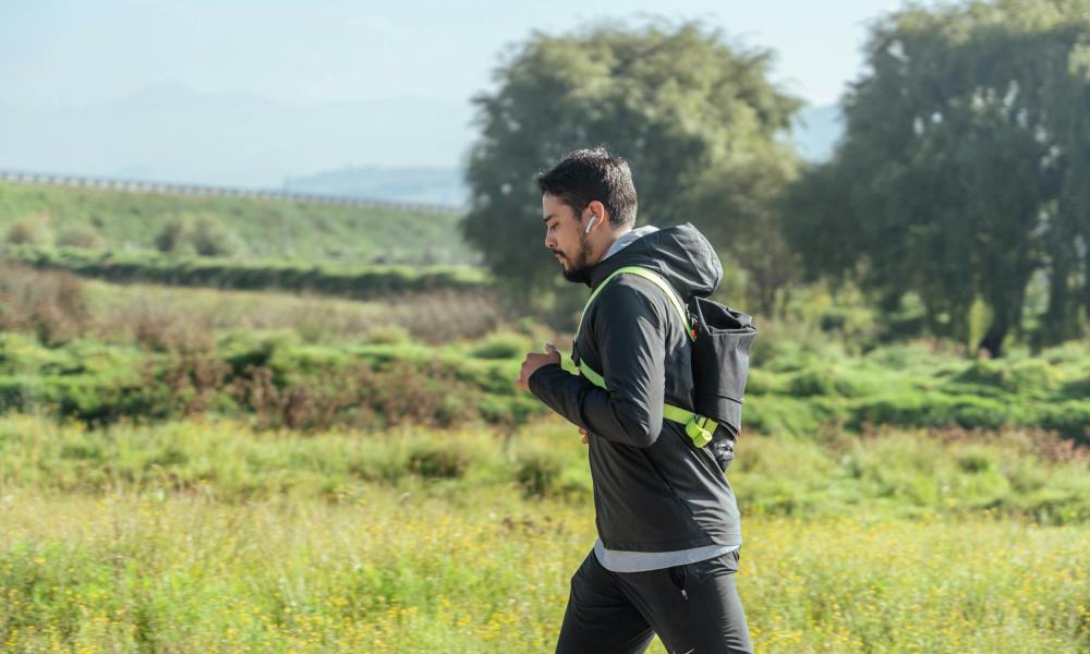 Man jogging brisk walking outdoors in nature