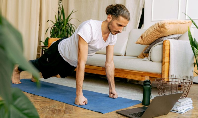 Man doing a plank on a yoga mat
