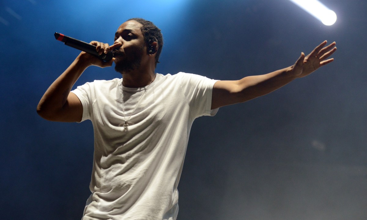 rapper Kendrick Lamar in concert on stage