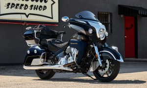 2025 Indian Motorcycle Roadmaster Elite parked on a gravel parking lot hear the entrance of a motorcycle speed shop .