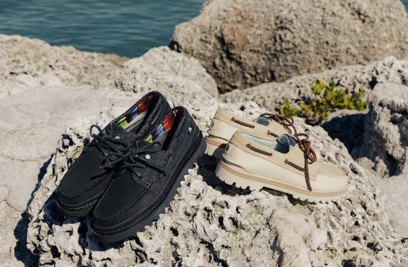 black and beige boat shoes on dirt