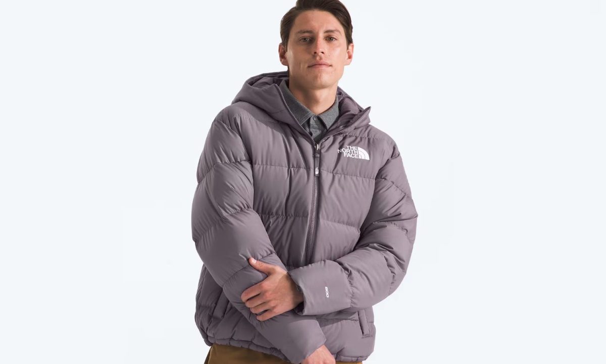 A man strikes a pose while wearing The North Face's Men's Frost Fall Hooded Jacket.