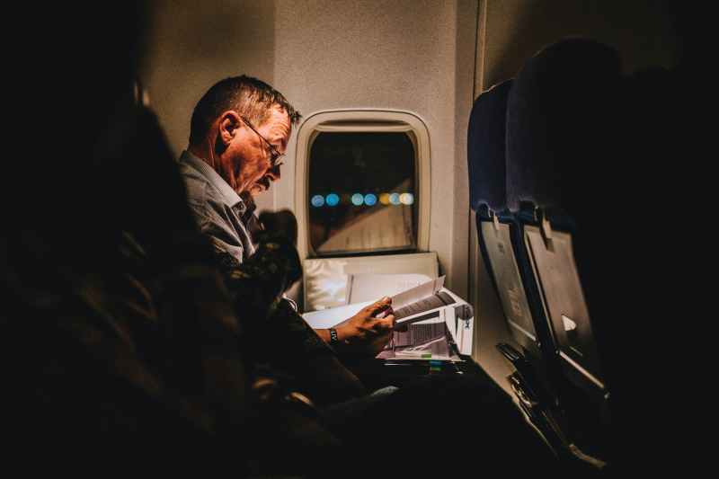 Man reading on a plane