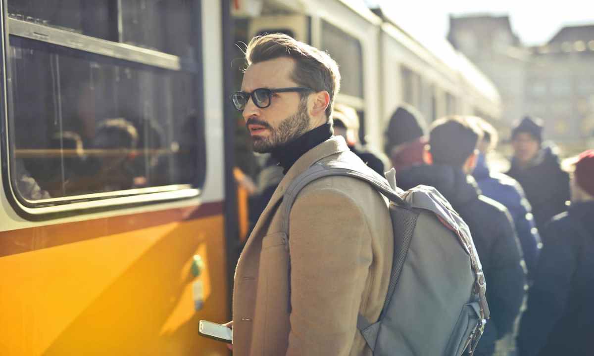 Getting on the train wearing a backpack