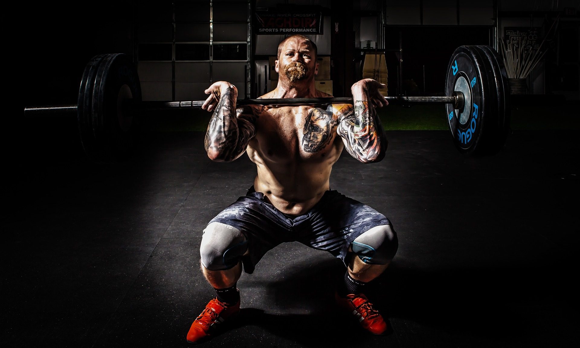 Man doing front barbell squat weighted squat