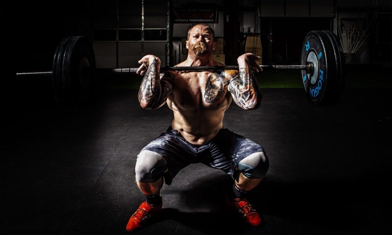 Man doing front barbell squat weighted squat