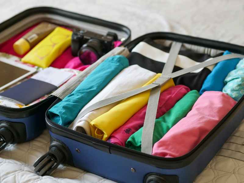 Open suitcase with clothes packed