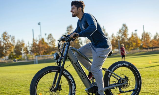 man cycling outside on the grass