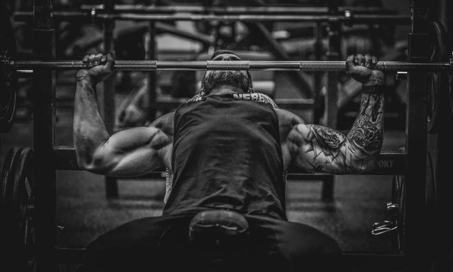 man lifting weights muscle bench press barbell black and white
