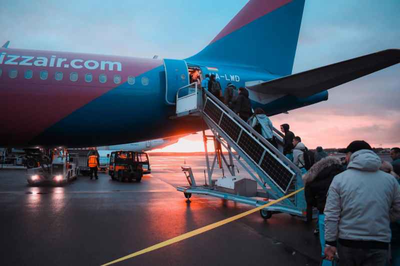 people boarding a plane outside