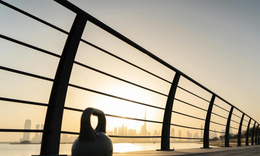 kettlebell at sunset next to fence workout