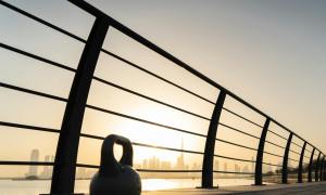 kettlebell at sunset next to fence workout