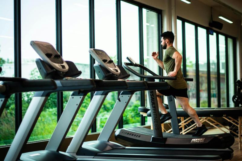 man on treadmill picture running by window