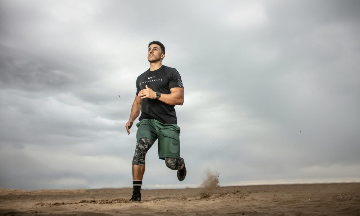 man exercising running around outdoors dark grey sky