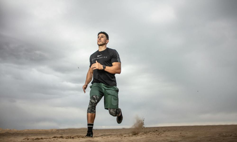 man exercising running around outdoors dark grey sky
