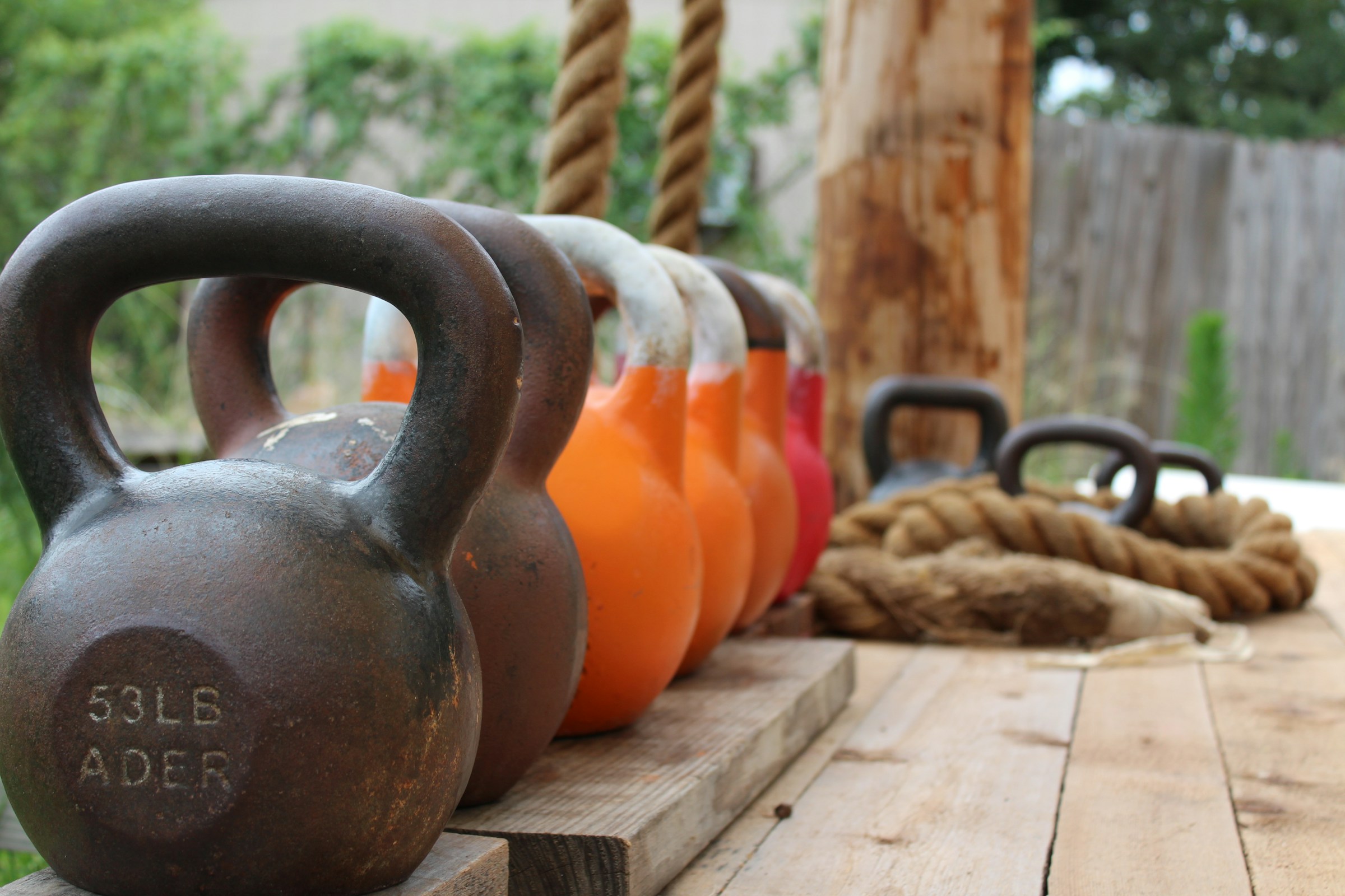 Row of kettlebells outside workout equipment