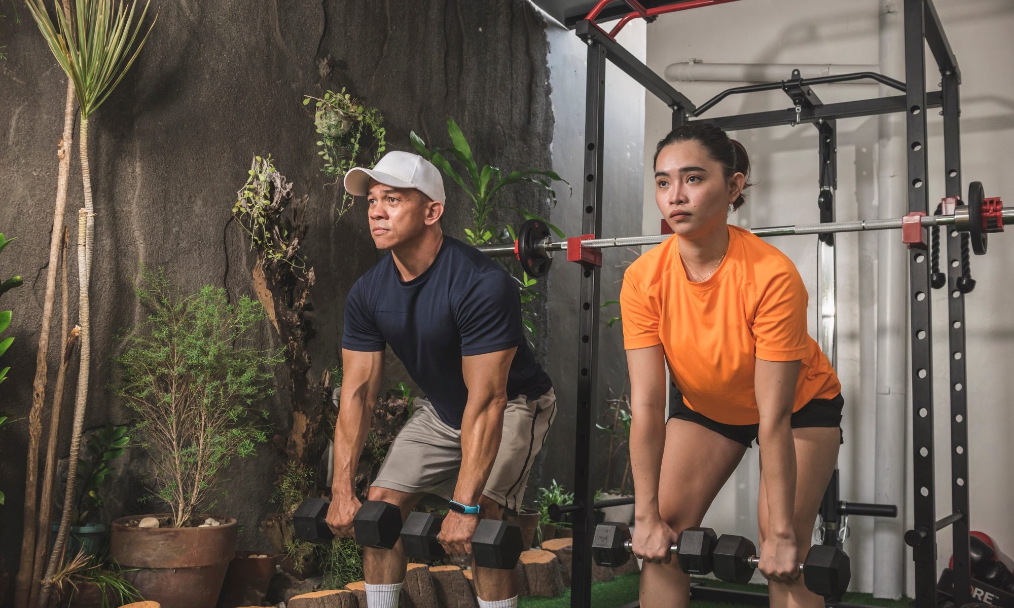 Dumbbell Romanian deadlift or RDL man and woman working out in gym with dumbbell